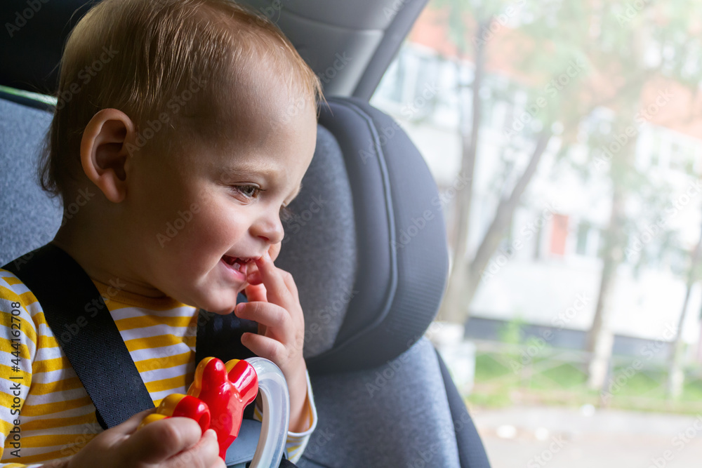 Happy baby sitting in car seat, playing. Happy baby sitting in car seat, playing.