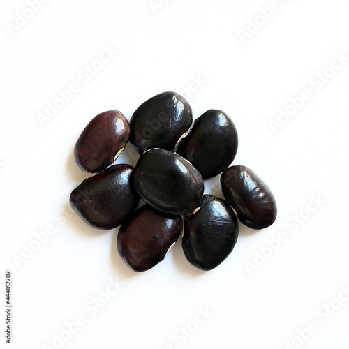 Black fava bean seeds on a white background