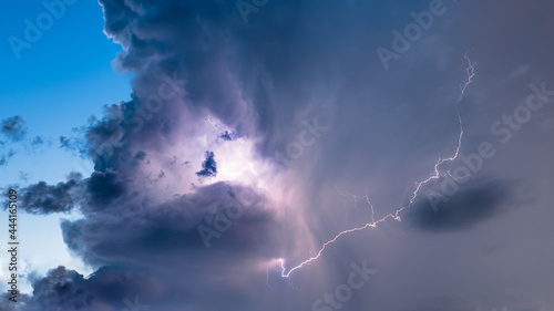 Lightning bolt in dramatic storm clouds nature and landscape background. Lightning storm and purple thunder clouds at night wallpaper