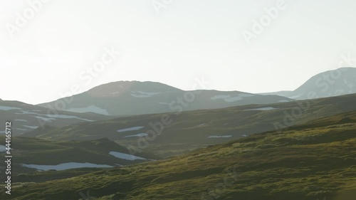 traveling on the Wilderness road in Stekenjokk, Sweden, at dusk on summer arrival. mountainscape with residual snow photo