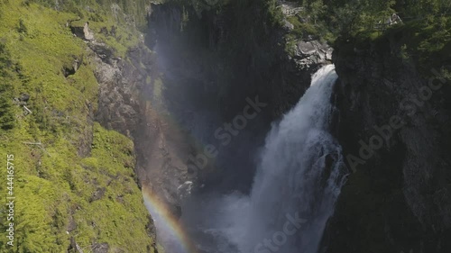 upper view of Hallingsafallet waterfall in Ostersund, Sweden, on sunny day in summer. Slowmotion tilt up photo
