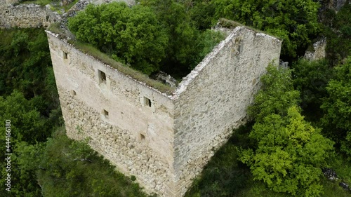 Convent de la Hoz Ruins With Dense Foliage In Hoces del Rio Duraton Natural Park In Segovia, Castilla y Leon, Spain. drone descend photo