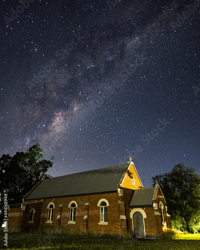 In the dark of the night a church situated under the milky way sky