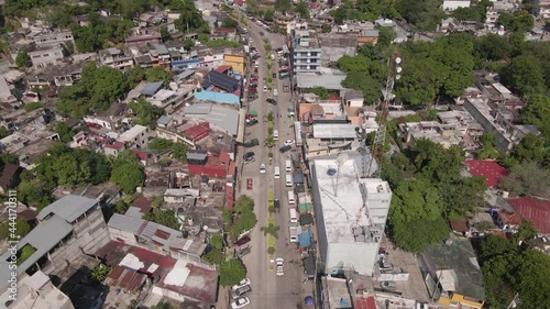 Tamazunchale Main Street, Mexico. Drone Aerial View, Central Buildings, Traffic in Green Valley Under Hills of San Luis Potosi Region, Revealing Tilt Up Shot photo