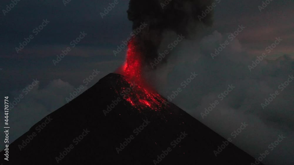 Guatemala volcano Fuego eruption aerial drone 4K video. Fly over Fuego volcano crater, beautiful sunset scenery.Red Lava. Aerial panorama shot