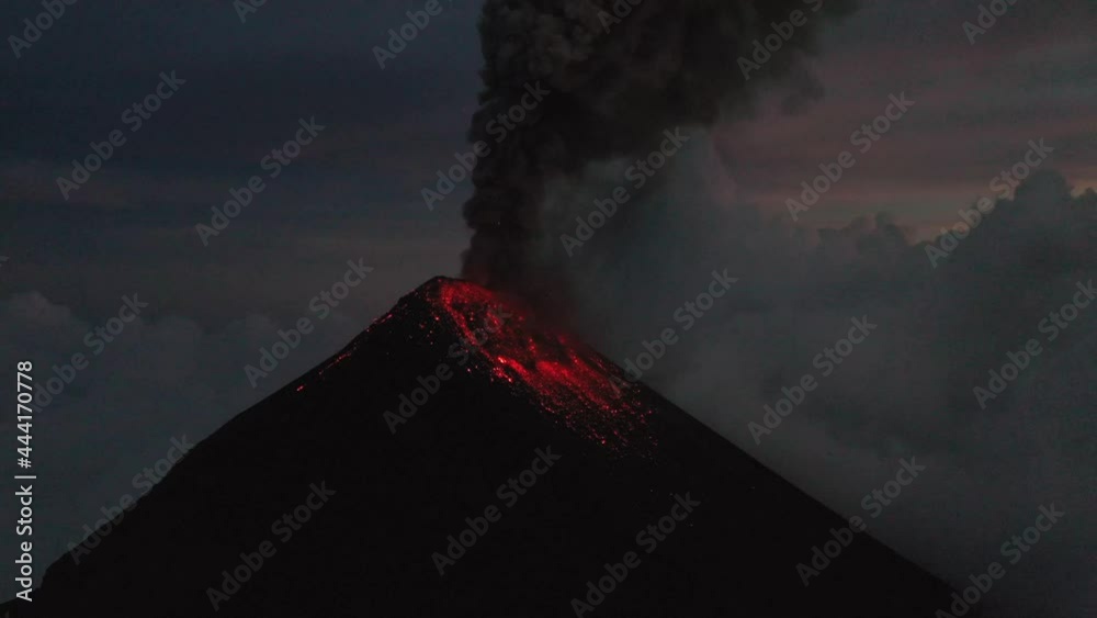Guatemala volcano Fuego eruption aerial drone 4K video. Fly over Fuego volcano crater, beautiful sunset scenery.Red Lava. Aerial drone shot.