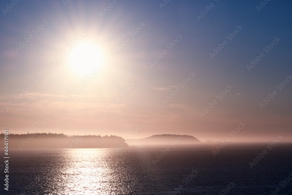 Sunset over islands shrouded with mist