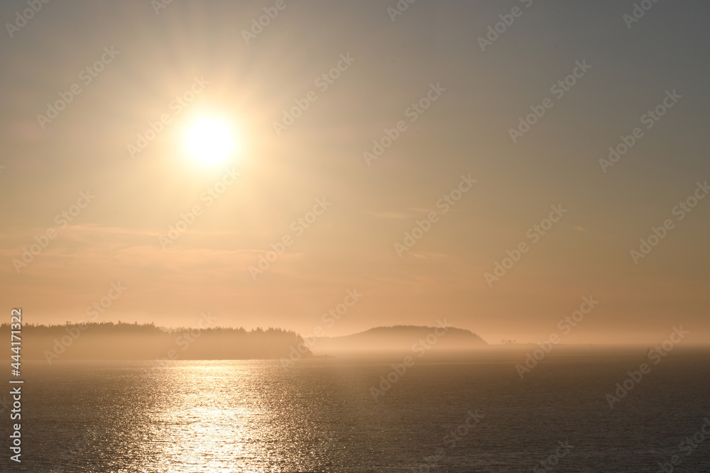 Sunset over islands shrouded with mist
