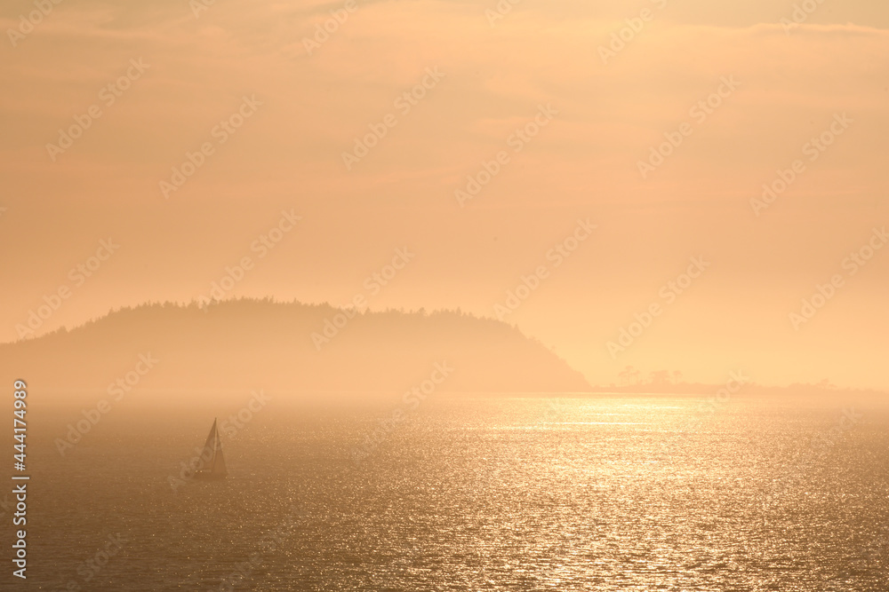 Sailboat in the misty islands at dusk Sailboat in the misty islands at dusk