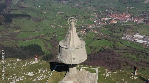 Aerial drone view of a large monument statue of the Virgin of Orduña on the top of Mount Txarlazo in the Basque Country photo