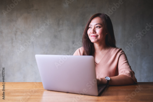 A beautiful young asian woman using and working on laptop computer © Farknot Architect
