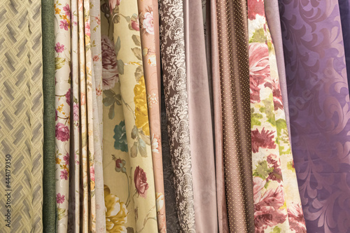 multicolored textures of fabrics on the shelves of stores close-up © Роман Заворотный