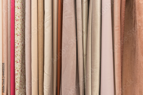 multicolored textures of fabrics on the shelves of stores close-up