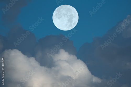 Full moon and clouds on the sky.