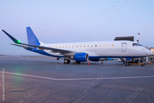 A passenger aircraft parked by the boarding bridge