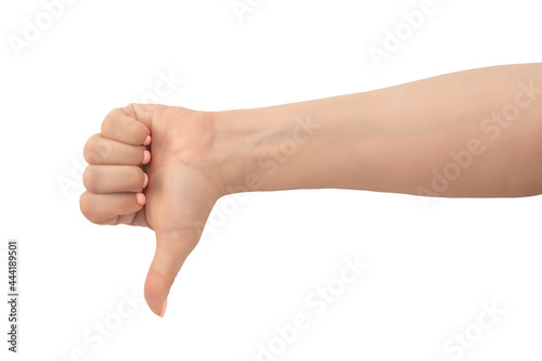 Woman hand thumb down sign isolated on white background. Hand shows a thumbs-down gesture. Close-up of female hand with a pink manicure gesture dislike, bad, disapproval isolated on white background