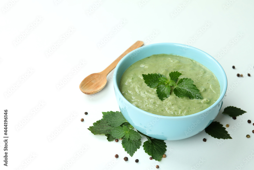 Concept of healthy food with nettle soup on white background Concept of healthy food with nettle soup on white background
