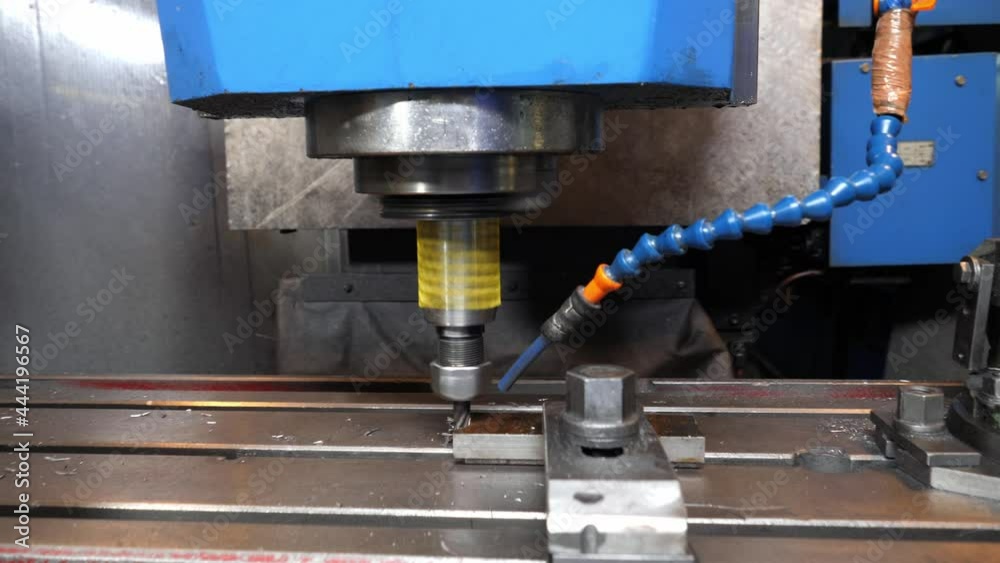 Contemporary drilling machine tool makes hole in metal detail in light