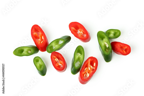 Green and red hot chili peppers slices isolated on white background