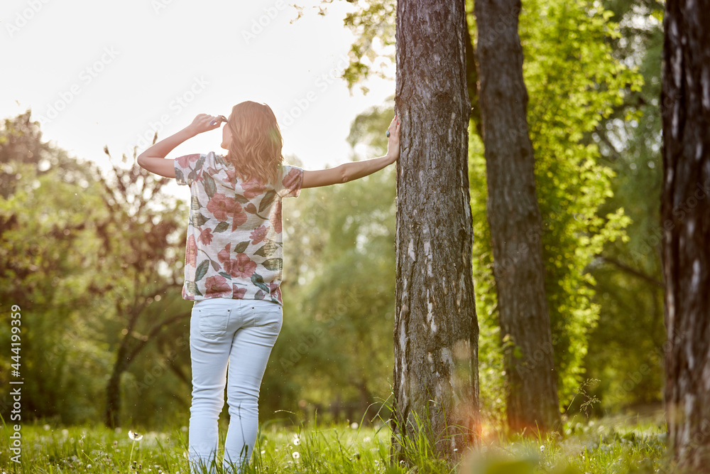 Woman in park outdoors feeling happy and powerful. Woman in park outdoors feeling happy and powerful.