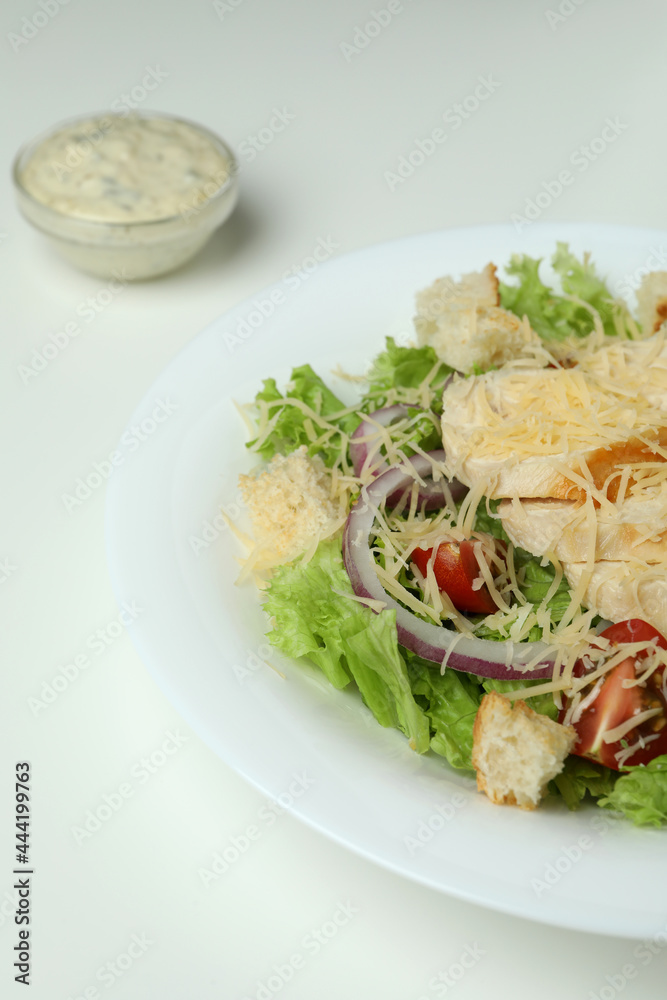Concept of tasty eating with Caesar salad on white background