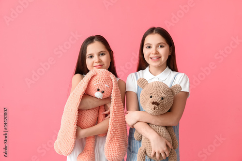 Cute twin girls with toys o...