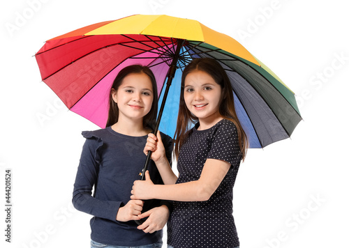 Cute twin girls with umbrella on white background