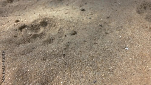 Sandy coast close up. Blurred defocused footage. Material for construction work.