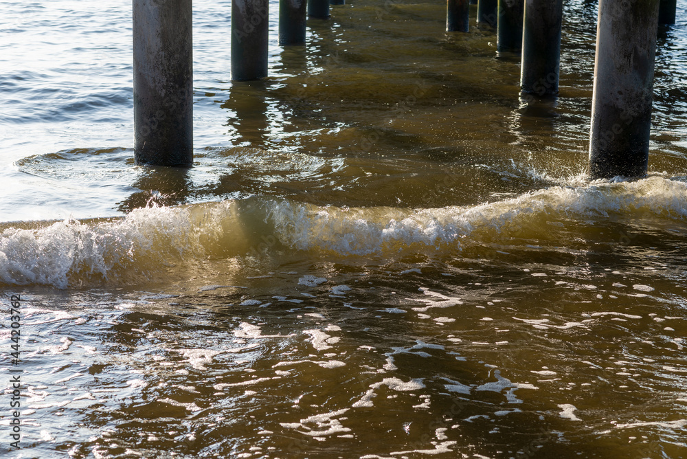 custom made wallpaper toronto digitalColumnar bridge piers at sunset.View under the bridge into sea with sunset,Background for travel.