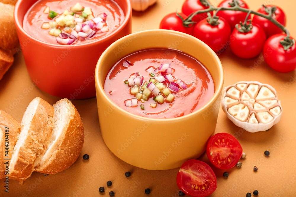 Bowls with tasty gazpacho on color background, closeup Bowls with tasty gazpacho on color background, closeup