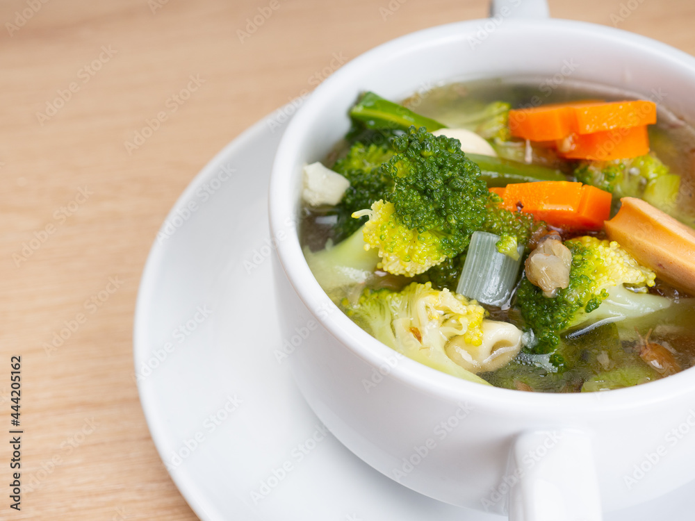 Vegetables soup that contain sausage, broccoli, carrots, etc on a white porcelain bowl Vegetables soup that contain sausage, broccoli, carrots, etc on a white porcelain bowl