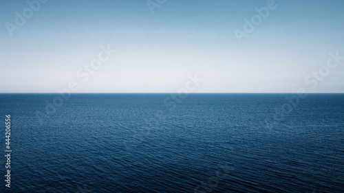 Blue Ocean with the sky on blackground, split image betwenn the sea and sky 