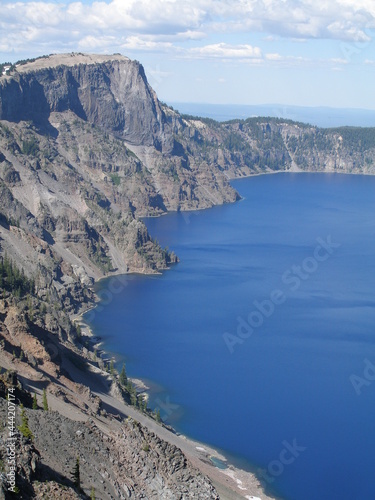 the steep cliffs of Crater Lake national park and deep blue lake along the rim drive, oregon