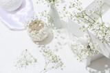 Wooden boxes with beautiful gypsophila flowers on light table, closeup