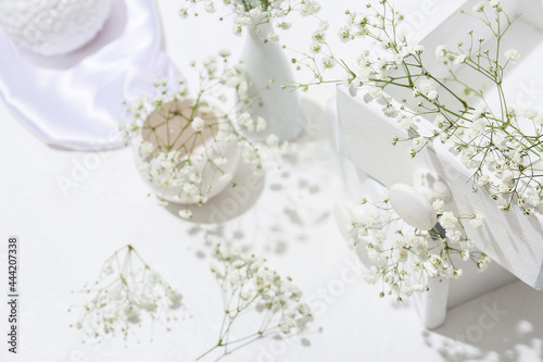 Wooden boxes with beautiful gypsophila flowers on light table, closeup