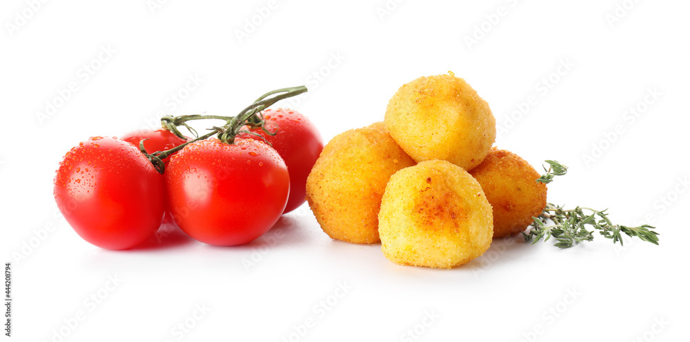 Fried potato balls and tomatoes on white background Fried potato balls and tomatoes on white background