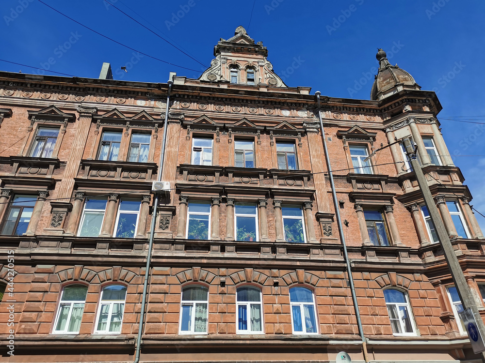 The facade of an old residential building on one of the streets of Vyborg on a sunny summer day.