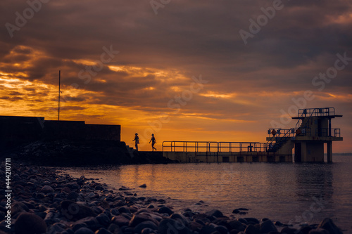 Sunset scene on Blackrock diving board in Galway