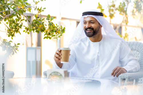 Middle Eastern Arab Emirati man at the Cafe in Dubai, United Arab Emirates photo