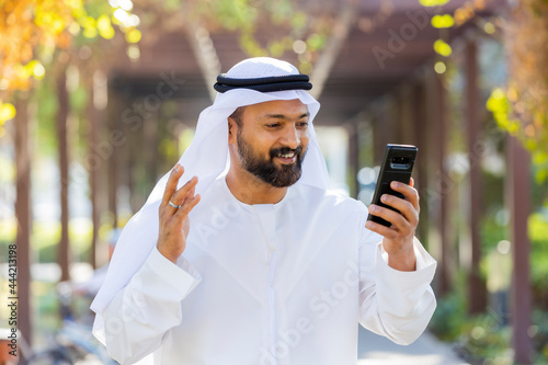 Photography Middle Eastern Arab Emirati Vlogger holding mobile phone