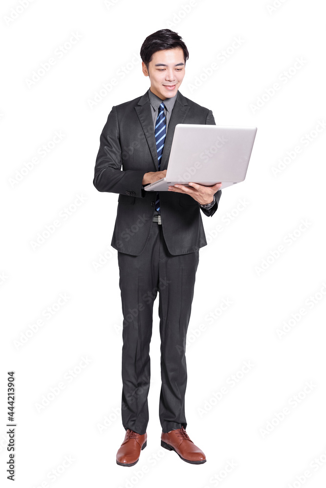 Young handsome businessman standing and holding  laptop .Isolated on white background.