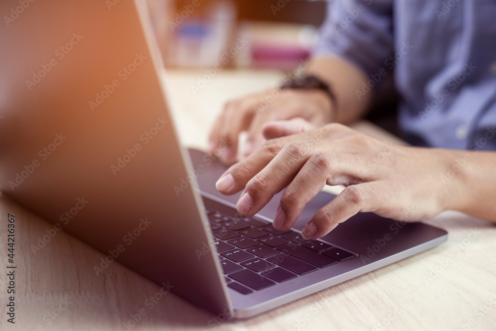 Hands of business people working remotely at home, Man typing on laptop or computer Hands of business people working remotely at home, Man typing on laptop or computer