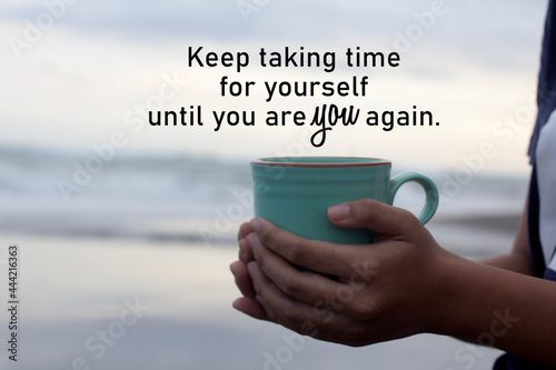 Inspirational words - Keep taking time for yourself until you are YOU again. With hands of young woman holding cup of hot coffee or tea on beach background. Self love and care concept. photo