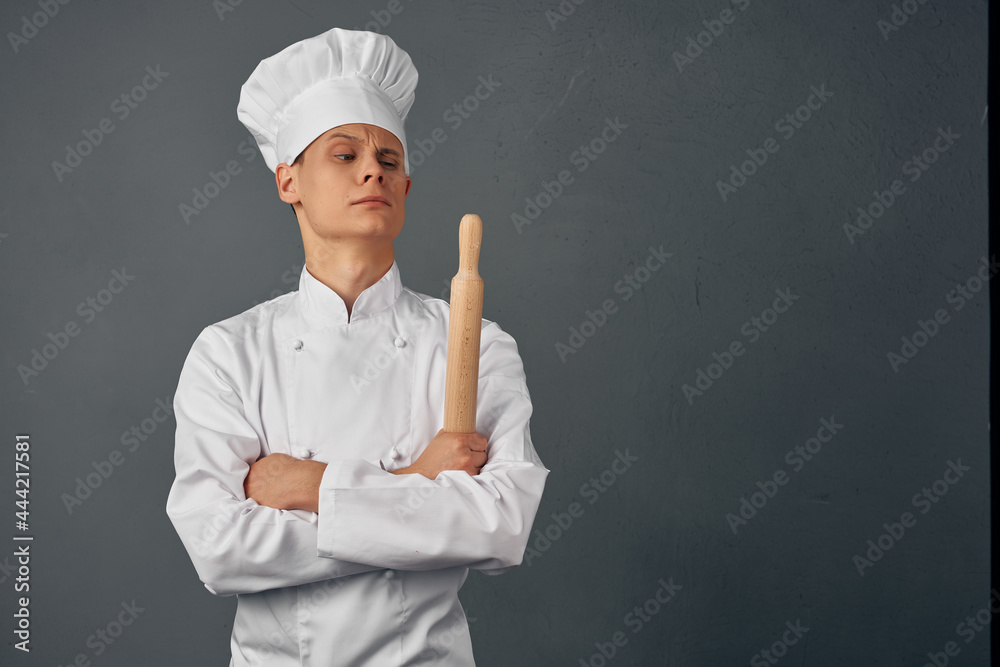 a man in a chef's uniform working in a restaurant cooking a man in a chef's uniform working in a restaurant cooking