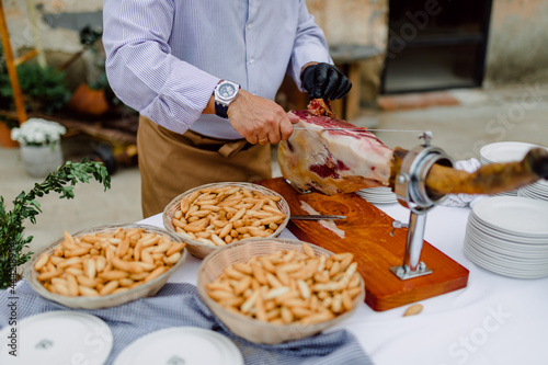 Quadro em tela Hombre corta jamón serrano en evento