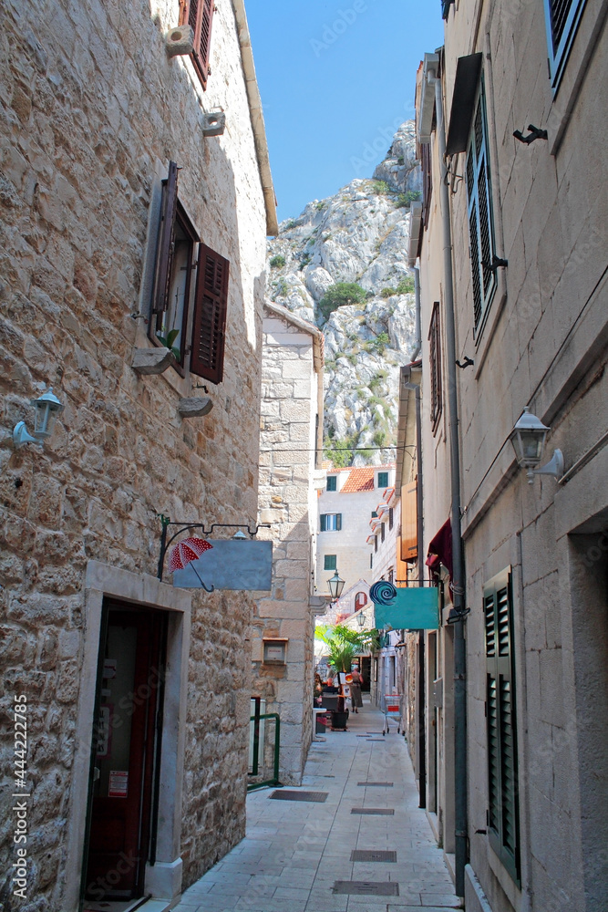 Fototapeta premium narrow street with stone buildings, Omis, Croatia