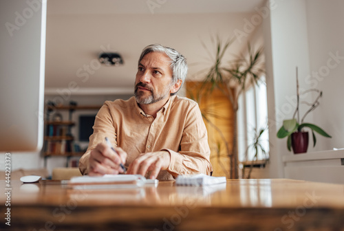 Adult man, organizing his busy day at work.