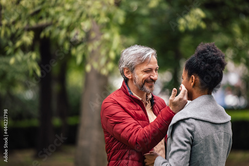 Adult man, affectionately touching his wife.