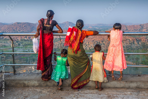 South Indian women looking at the mountains from Monkey Hill Hampi, Karnataka, India