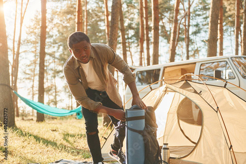 African american man is traveling alone in the forest at daytime at summer